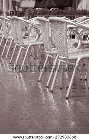 Cafe Tables and Chairs in St Marks Square, Venice, Italy in Black and White Sepia Tone