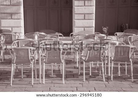 Cafe Table and Chairs in St Marks Square; Venice; Italy in Black and White Sepia Tone