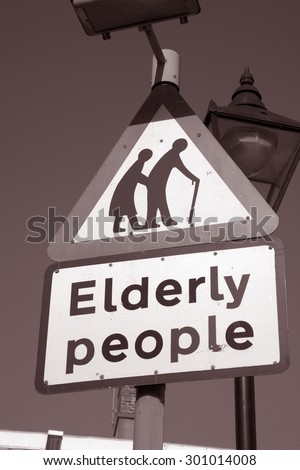 Elderly People Sign against Sky Background in Black and White Sepia Tone