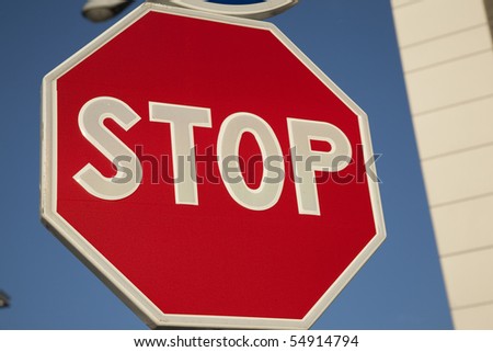 Close-up of red stop sign in urban setting