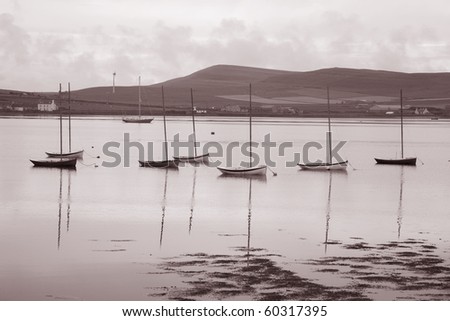 Boats in Orkney Islands, Scotland in sepia black and white tone