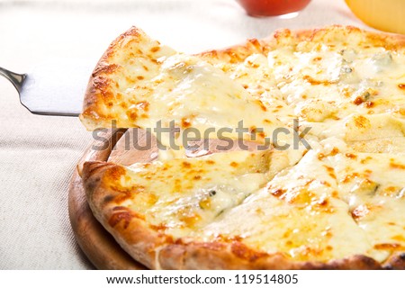 Pizza quattro fromaggi on a wooden board