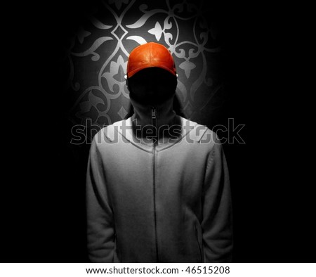 Red hat stands out of a black and white photo of a faceless man