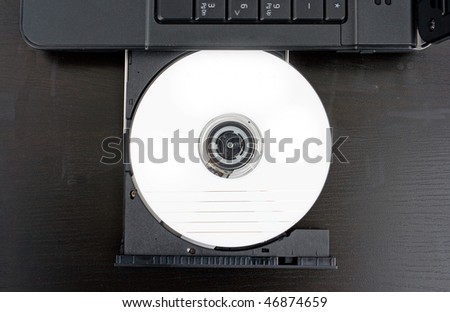 DVD placed in the DVD ROM of a black laptop