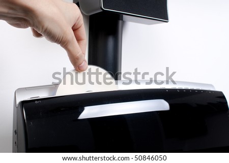 Hand inserting a DVD in a fancy player