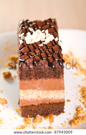 Chocolate cakes with coconut flakes (focus on white flakes)