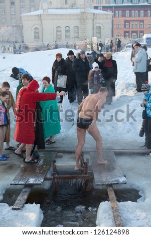 SAINT-PETERSBURG, RUSSIA-JANUARY 19: People in ice-hole dip three times in Epiphany celebration on January 19, 2013 in Saint-Petersburg, Russia.  Orthodox tradition in Epiphany (Holy Baptism)