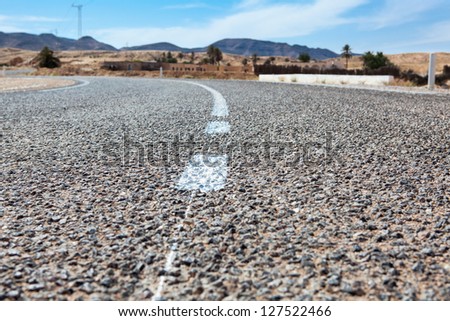 Close up of asphalt road with white lines
