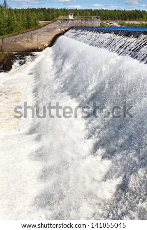 Water falls from dam overflow. Man made water reservoir ,