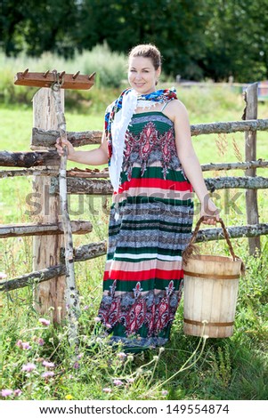 Country lifestyle in village. Woman in dress