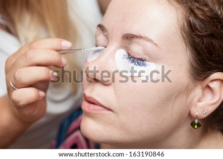 Female eyelashes dyeing with permanent blue makeup