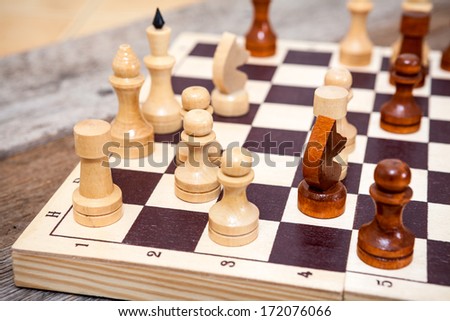 Chess pieces on wooden board table
