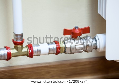 Central heating radiator with opened valve on pipe