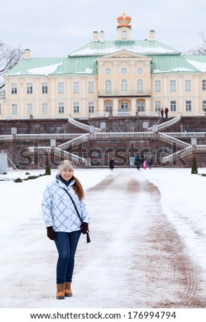 Woman in winter clothes standing in front of the main staircase Menshikov Palace in Oranienbaum