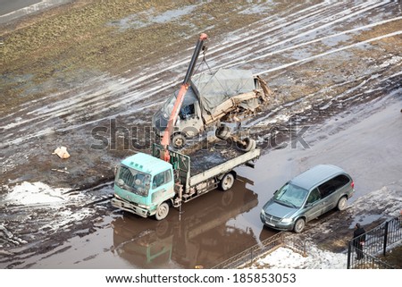 SAINT-PETERSBURG, RUSSIA - CIRCA FEBRUARY, 2014: Tow truck loads banding after road crash freight car for scrappage. Government scrappage scheme