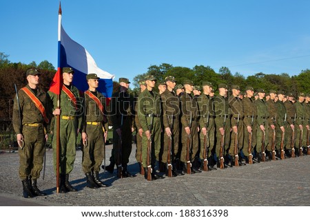 SAINT-PETERSBURG, RUSSIA - May 26, 2011: Russian soldiers with flag of Russia are in the line near the monument to Peter the Great. Celebration of the City Day.