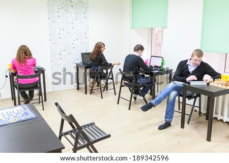 Young adults surfing internet in co-working room