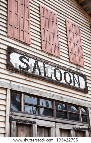 Saloon sign on western wooden building