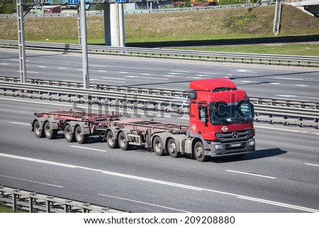 SAINT-PETERSBURG, RUSSIA - CIRCA JULY, 2014: Semitrailer truck drives on the Saint-Petersburg city highway without container. The federal public road A-118