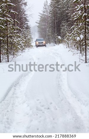 Offroad vehicle and deep trucks in snow road, blizzard