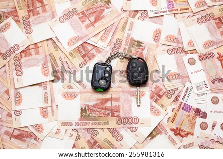 Car key laying on Russian cash money