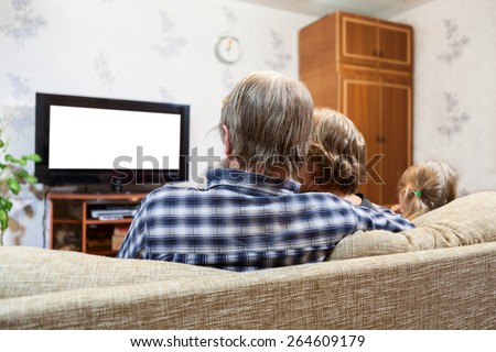 Caucasian parents and daughter sitting on the couch and watching tv, isolated white screen