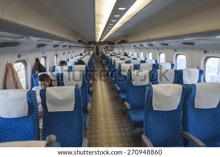 TOKYO, JAPAN - CIRCA APR, 2013: Interior of Japanese bullet train Hikari. Passengers seat in half-empty wagon. Shinkansens of Japan