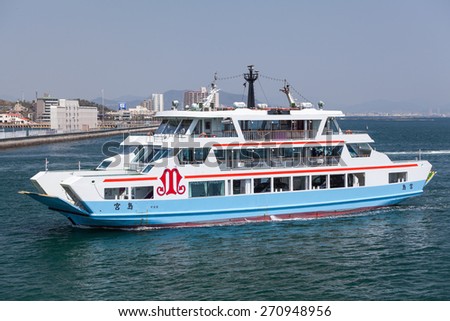 MIYAJIMAGUCHI, JAPAN - CIRCA APR, 2013: The ferry of Miyajima Matsudai Kisen company comes to Miyajimaguchi town pier. Two ferry-boats for Itsukushima island travel. The Hiroshima gulf, Japan.