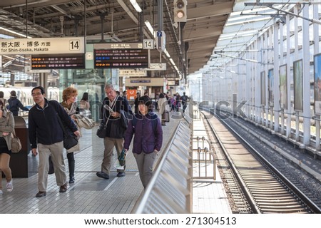 TOKYO, JAPAN - CIRCA APR, 2013: People walk on the Tokyo station platform. Empty railway. The Tokyo Station is a railway station in the Marunouchi district of Chiyoda