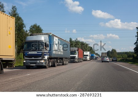 TVER OBLAST, RUSSIA - CIRCA AUG, 2011: Traffic jam from the trucks is on the highway from Moscow to St. Petersburg, E-95. Vehicles stand on roadside due an accident is ahead