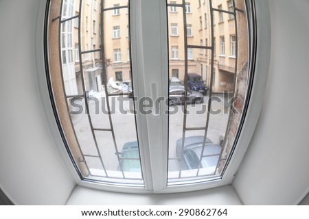 Plastic pvc window with bars screen to the courtyard