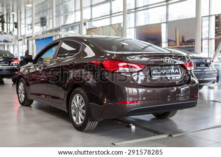 ST. PETERSBURG, RUSSIA - CIRCA APR, 2015: Brown Hyundai Elantra car is exhibited in auto dealership showroom. The Rolf Lahta is a official dealer of Hyundai
