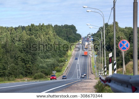 Vehicles drive on the M10 highway. The M10 is a federal highway connecting two largest cities, Moscow and St. Petersburg, Russia