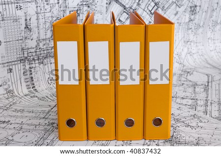 Row from the yellow file folders with clean blank for your text. Black and white project drawings are background