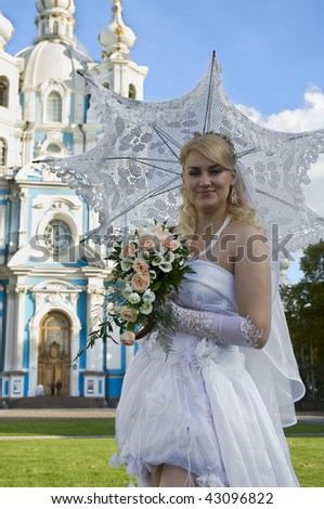 The beautiful bride about a temple before wedding. A sunny day. A church is on background