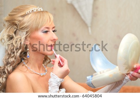 stock photo Bride of a beautiful young blonde girl does makeup