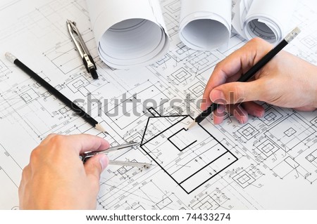 Project drawings and human hands drawing a house by pencil on paper