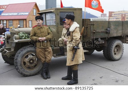 SAINT-PETERSBURG, RUSSIA – NOVEMBER 4: Military performance in celebration of National Unity Day. Three soviet soldiers standing near army lorry on November 4, 2011 in Saint-Petersburg, Russia.