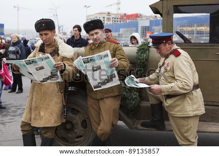 SAINT-PETERSBURG, RUSSIA – NOVEMBER 4: Military performance in celebration of National Unity Day. Three soviet soldiers reading newspapers on November 4, 2011 in Saint-Petersburg, Russia.