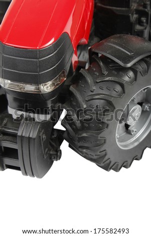 The photo of a red tractor on a white background
