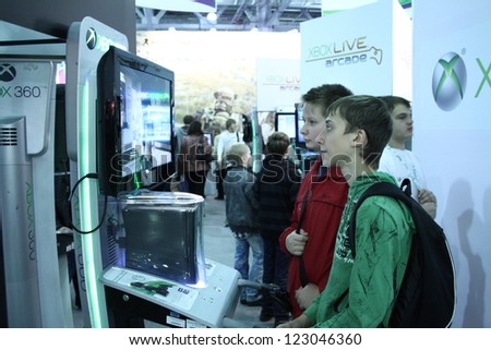 MOSCOW- OCTOBER 7:  Unidentified young people playing video games at the international exhibition of  the entertainment industry, Igromir on October 7, 2012 in Moscow