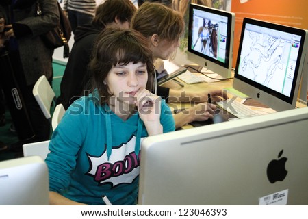 Moscow- October 7: Unidentified Young Girl Artist Draws A Digital Pen At The International Exhibition Of The Entertainment Industry, Igromir On October 7, 2012 In Moscow