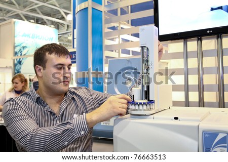 MOSCOW - APRIL 28: Male researcher uses gas chromatograph Chromatec Crystal at the international exhibition of analytical and laboratory equipment in Russia and CIS on April 28, 2011 in Moscow, Russia