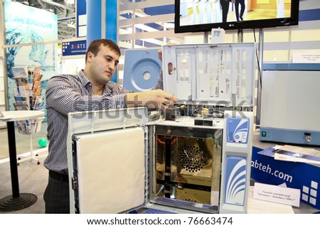 MOSCOW-APRIL 28:Male researcher uses gas chromatograph Chromatec Crystal at the international exhibition of analytical and laboratory equipment in Russia and CIS on April 28, 2011 in Moscow, Russia.