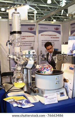 MOSCOW - APRIL 28:Man looks at the rotary evaporator with integrated heating bath at the international exhibition of analytical and laboratory equipment in Russia on April 28, 2011 in Moscow, Russia.