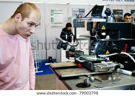 MOSCOW - APRIL 19: Demonstration the robot for PCB at the international exhibition of  electronic industry ExpoElectronica, ElectronTechExpo, LEDTechExpo on April 19, 2011 in Moscow