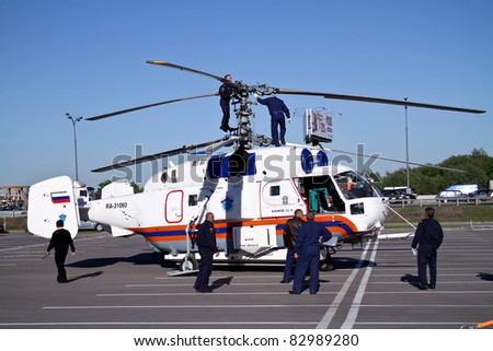 MOSCOW - MAY 19: Engineer inspect the propeller Helicopter KA-32A at the international exhibition of  the helicopter industry, HeliRussia on May 19, 2011 in Moscow