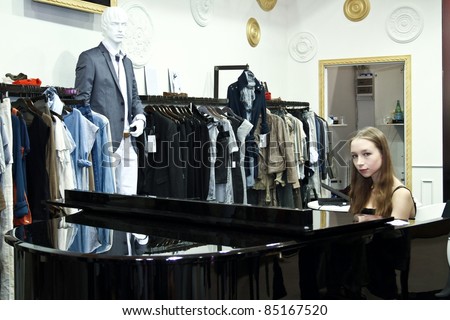MOSCOW - SEPTEMBER 7: Unidentified woman plays the piano at the international exhibition of  the fashion industry, Collection Premiere Moscow, CPM on September 7, 2011 in Moscow