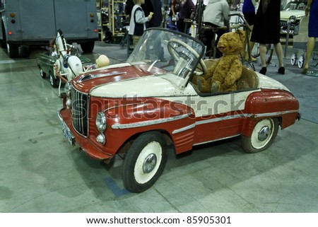 MOSCOW - SEPTEMBER 16: Bear in old toy car ZIM at the international exhibition of the technical antiques on September 16, 2011 in Moscow, Russia