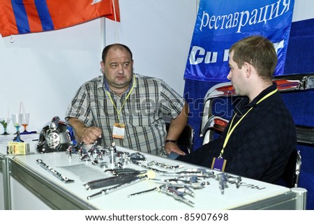 MOSCOW - SEPTEMBER 16: Men sell spare parts for vintage cars at the international exhibition of the technical antiques on September 16, 2011 in Moscow, Russia